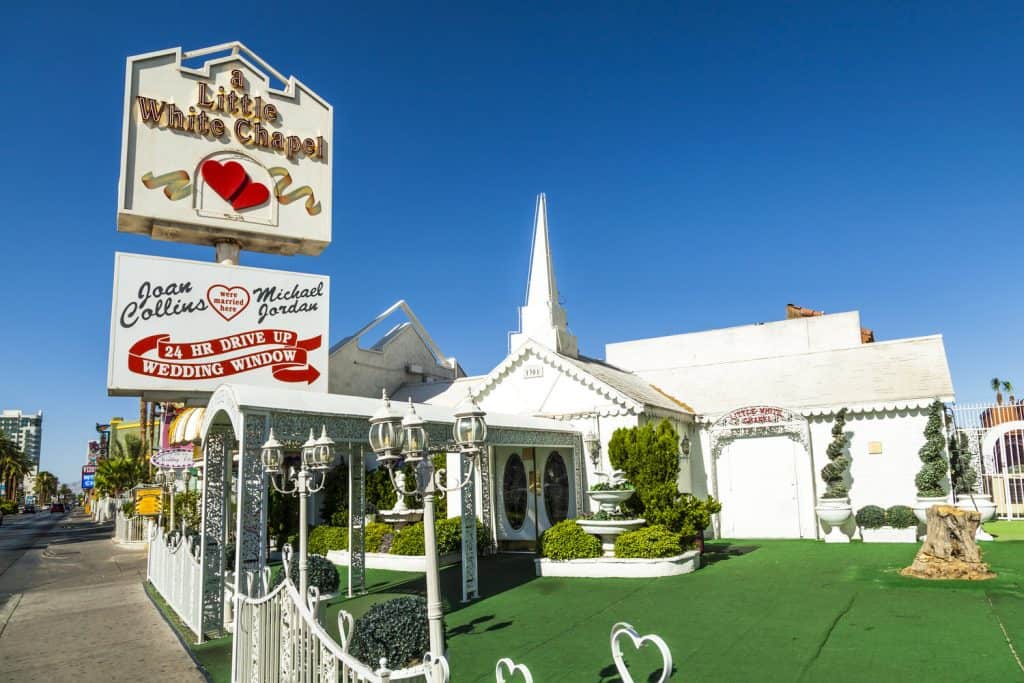 A small wedding chapel with a small outdoor garden in front of it. 