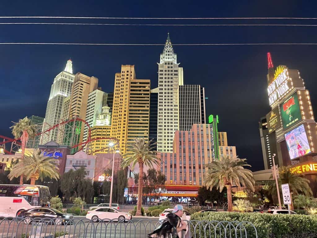 View from across the street of a large resort that is styled after the New York City skyline.
