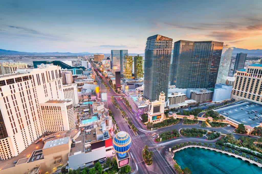 Aerial view of the city of Las Vegas under an orange sky.