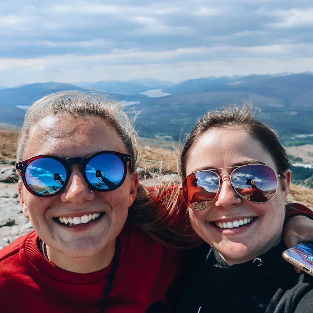 KP and Jessie smiling with mountains behind them